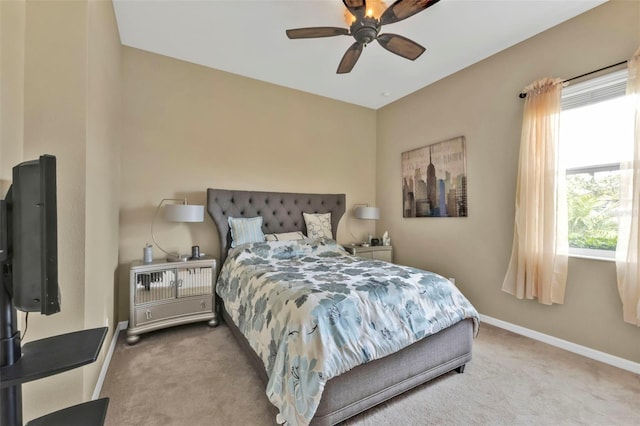 carpeted bedroom featuring baseboards and a ceiling fan