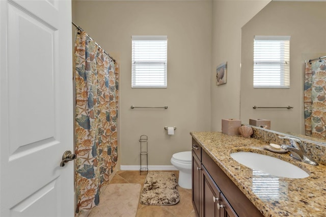 full bath with a healthy amount of sunlight, tile patterned flooring, toilet, and vanity