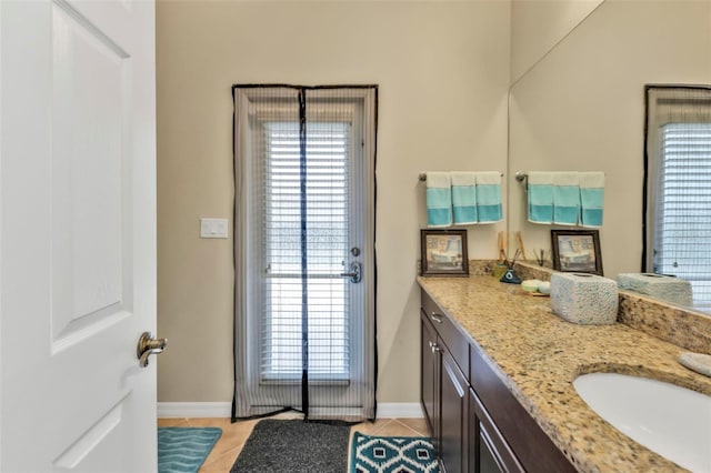 bathroom featuring baseboards, vanity, and tile patterned floors