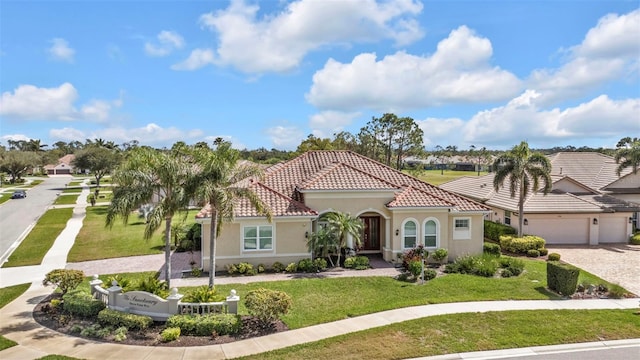 mediterranean / spanish-style home with a garage, a tile roof, decorative driveway, stucco siding, and a front yard