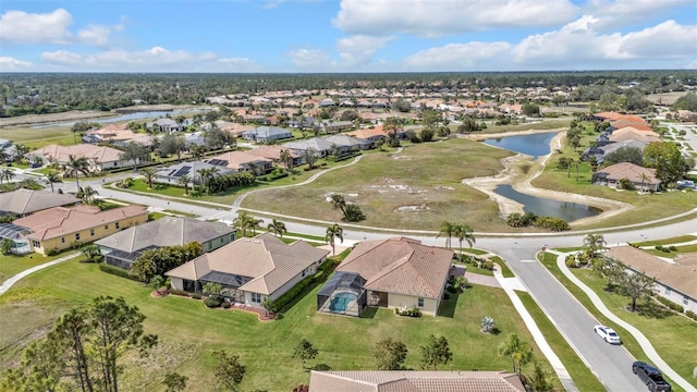 drone / aerial view featuring a residential view and a water view