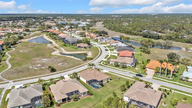 bird's eye view featuring a water view and a residential view