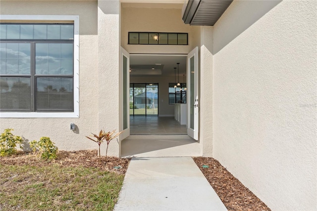 entrance to property with stucco siding