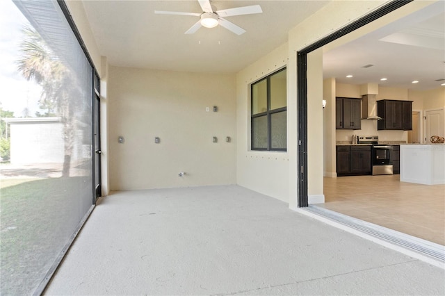 unfurnished sunroom with a ceiling fan