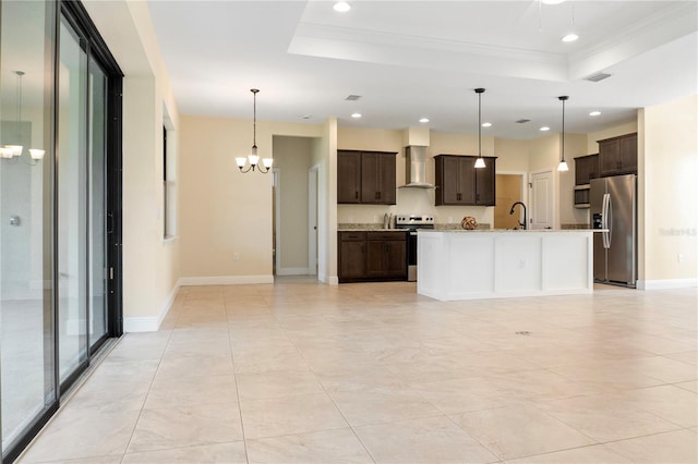 kitchen with stainless steel appliances, a raised ceiling, visible vents, a sink, and wall chimney exhaust hood