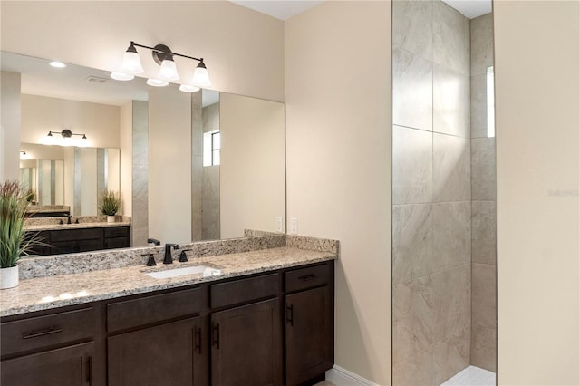 full bathroom featuring walk in shower and vanity