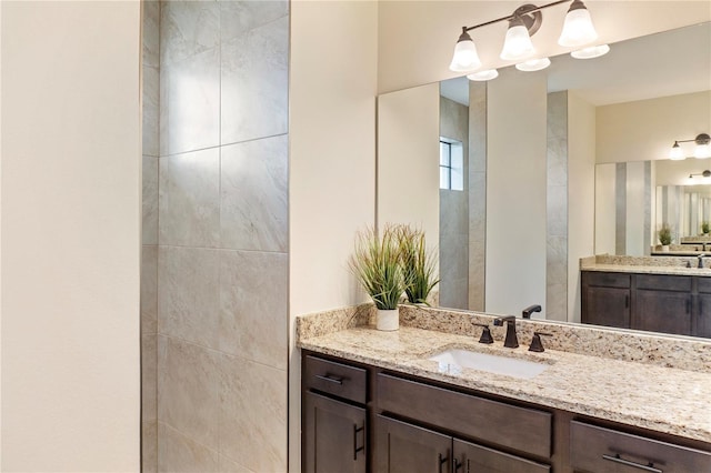 bathroom featuring two vanities and a sink