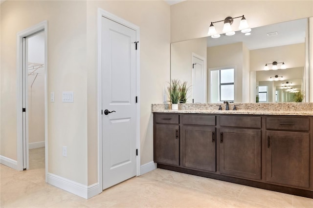 bathroom with vanity and baseboards