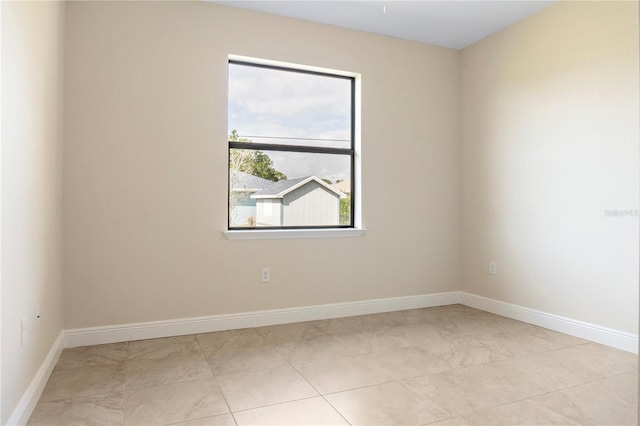 spare room featuring baseboards