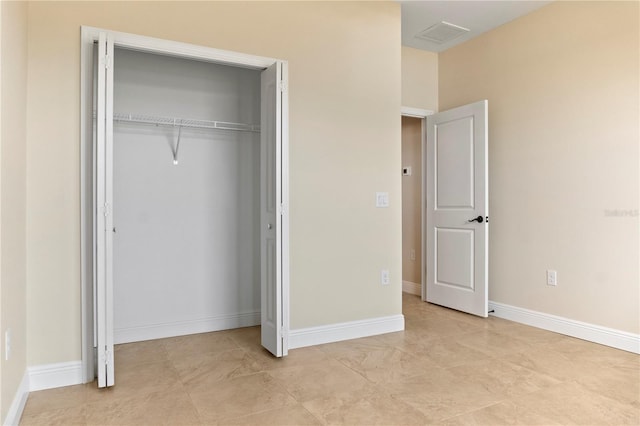 unfurnished bedroom featuring a closet, visible vents, and baseboards