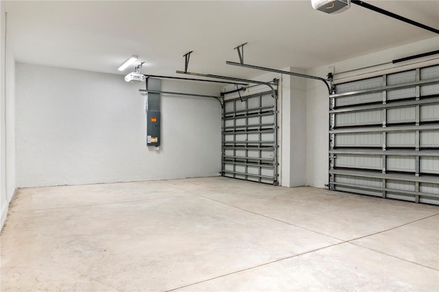 garage featuring electric panel and a garage door opener