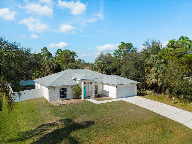 ranch-style home featuring an attached garage, fence, concrete driveway, stucco siding, and a front yard