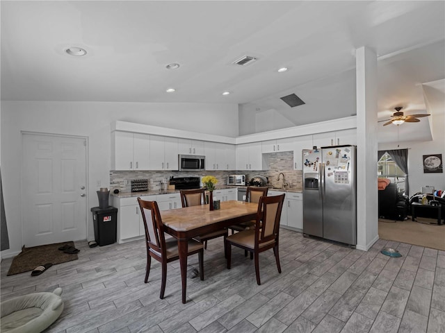 dining room with ceiling fan, recessed lighting, wood finish floors, visible vents, and vaulted ceiling