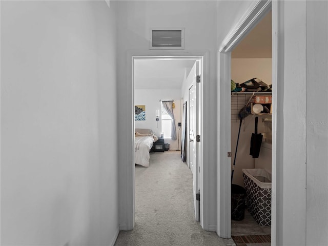 corridor featuring carpet floors and visible vents