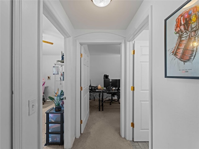 hall featuring light colored carpet