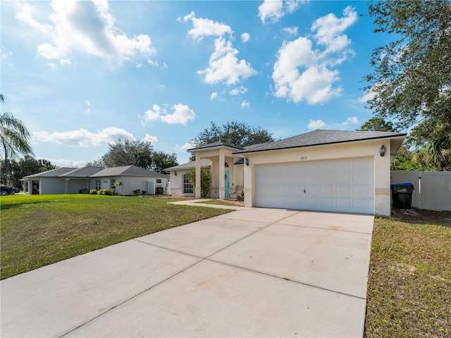 view of front facade with a front lawn, concrete driveway, an attached garage, and stucco siding