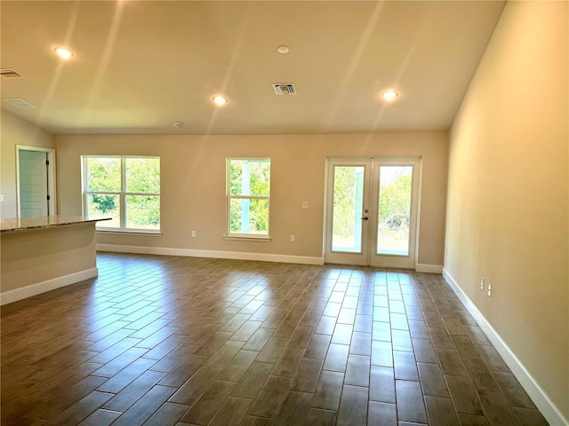 9590 Little Rock St, Port Charlotte, FL 33981 - unfurnished living room with dark wood-style floors, french doors, and recessed lighting