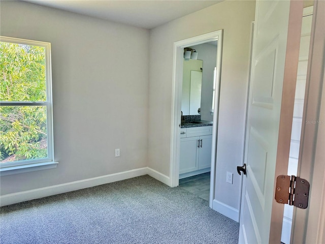 9590 Little Rock St, Port Charlotte, FL 33981 - unfurnished bedroom featuring light colored carpet, multiple windows, and ensuite bath