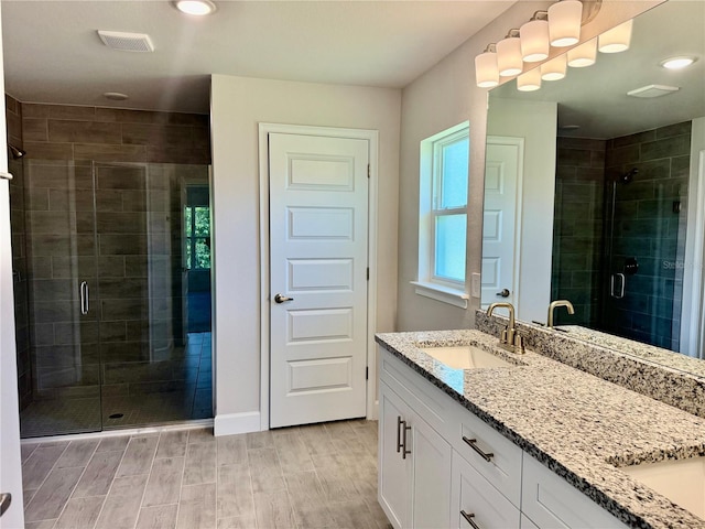 9590 Little Rock St, Port Charlotte, FL 33981 - bathroom with double vanity, a shower stall, wood finish floors, and recessed lighting