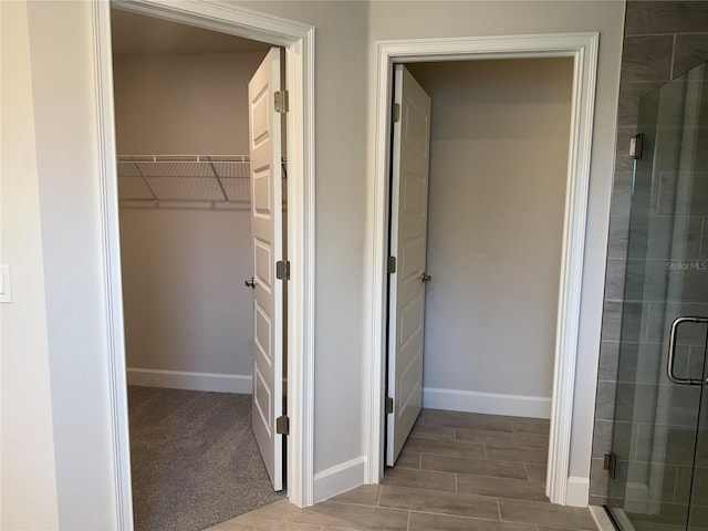 9590 Little Rock St, Port Charlotte, FL 33981 - bathroom featuring a stall shower and a walk in closet