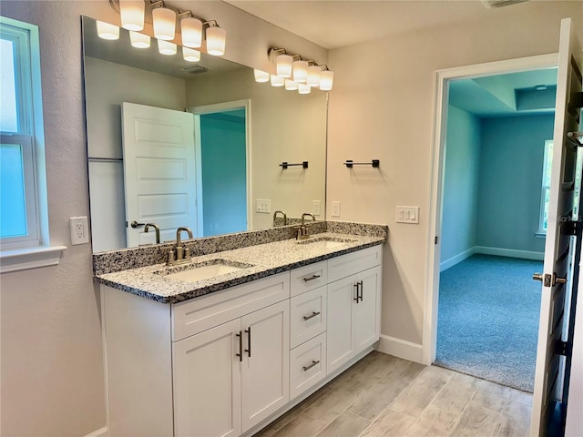 9590 Little Rock St, Port Charlotte, FL 33981 - bathroom featuring double vanity and wood finished floors