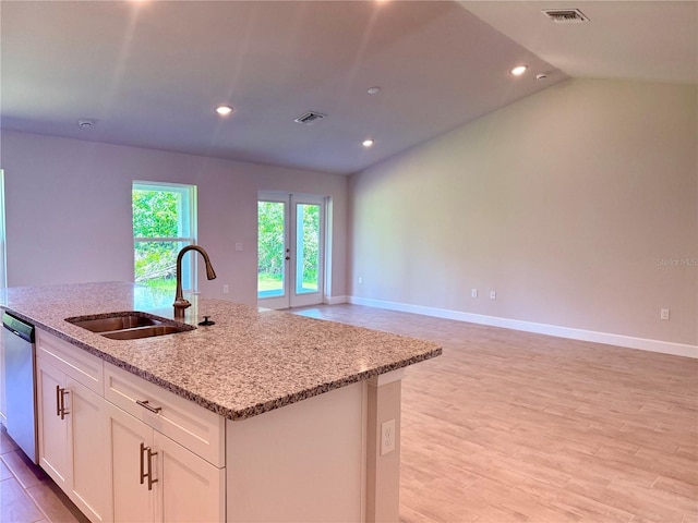 9590 Little Rock St, Port Charlotte, FL 33981 - kitchen featuring dishwasher, a center island with sink, white cabinetry, light stone counters, and recessed lighting