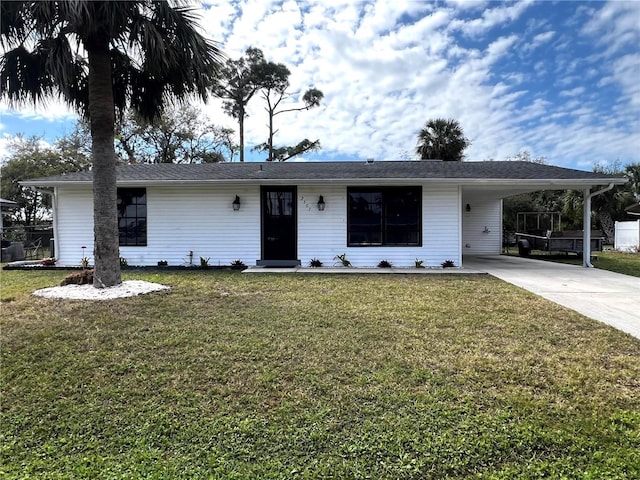 ranch-style house with driveway, an attached carport, and a front yard