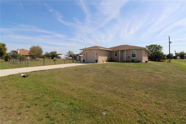 ranch-style home featuring a front yard, driveway, an attached garage, and fence