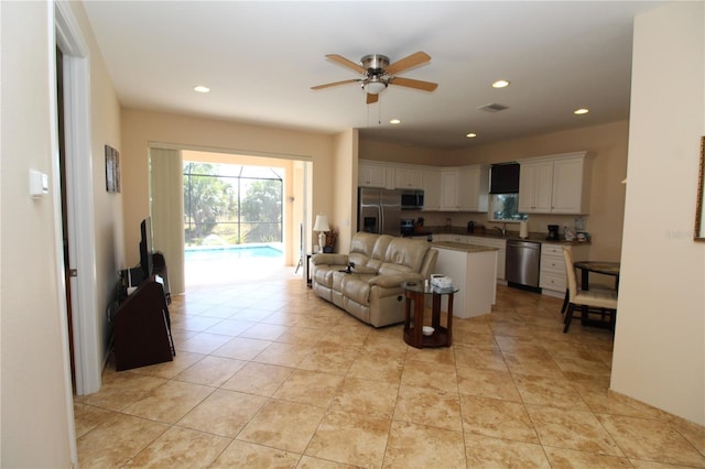 living area featuring recessed lighting, visible vents, and ceiling fan