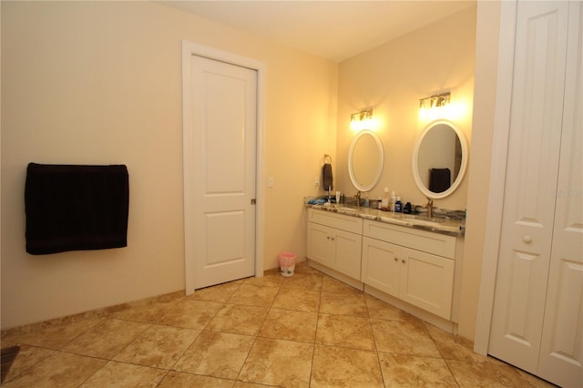 full bath featuring double vanity, a closet, tile patterned flooring, and a sink