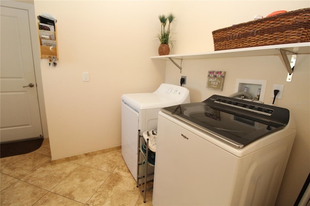 laundry room with washing machine and dryer, laundry area, baseboards, and light tile patterned floors