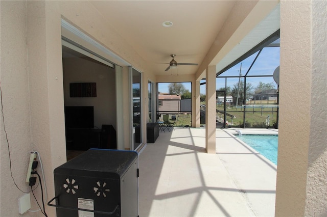 exterior space with a lanai, an outdoor pool, and ceiling fan