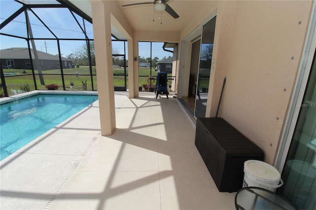 pool with a lanai, a patio area, and ceiling fan