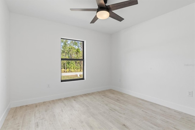 unfurnished room featuring a ceiling fan, light wood-style flooring, and baseboards