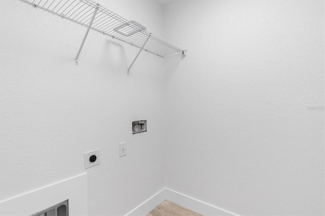 laundry room featuring laundry area, washer hookup, electric dryer hookup, and baseboards