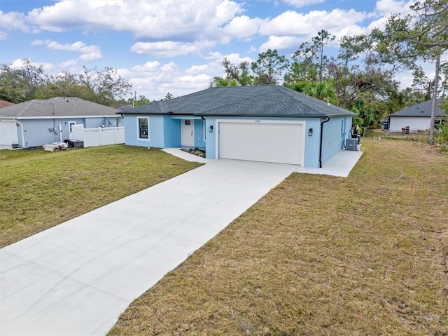 ranch-style home with stucco siding, a front yard, fence, a garage, and driveway