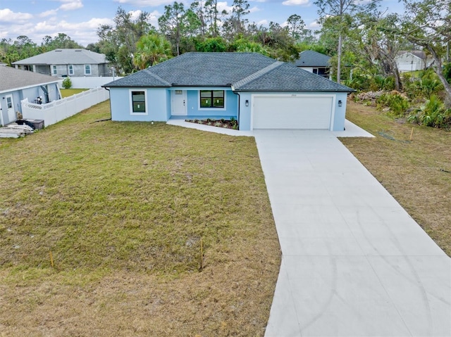 view of front of house with a garage, fence, a front lawn, and concrete driveway