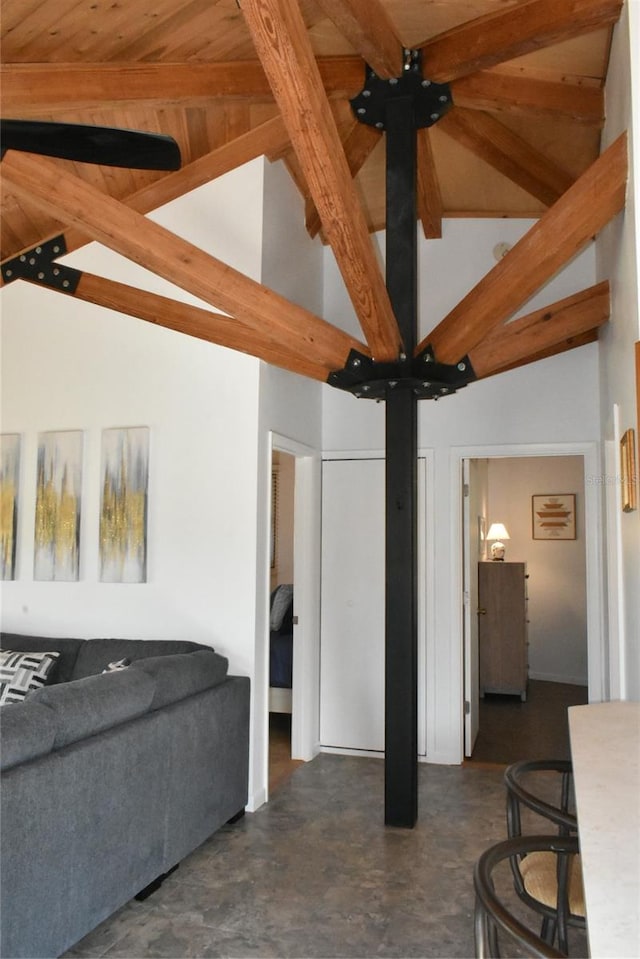 living room with concrete floors and lofted ceiling with beams