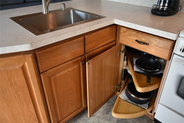 interior details featuring brown cabinets, light countertops, and a sink