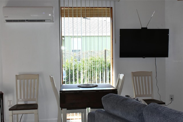 dining area featuring an AC wall unit