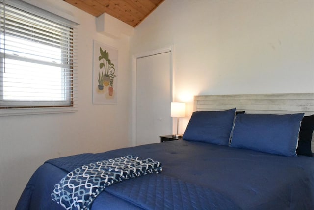 bedroom featuring vaulted ceiling and wood ceiling