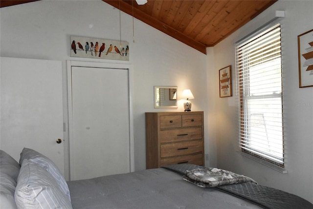 bedroom with lofted ceiling, a closet, and wooden ceiling