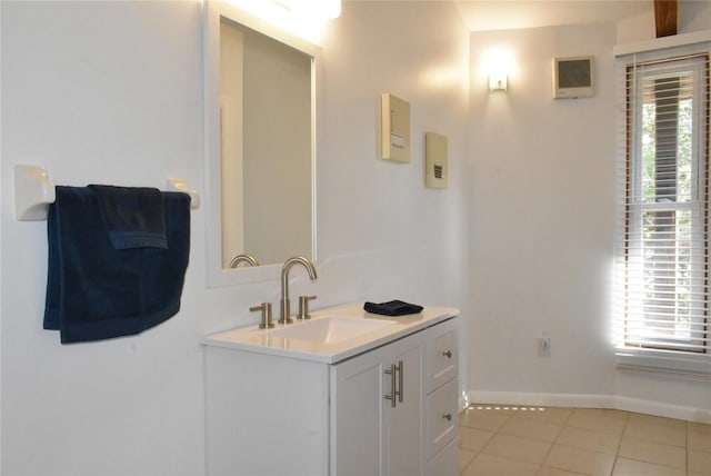 bathroom with baseboards, vanity, and tile patterned floors