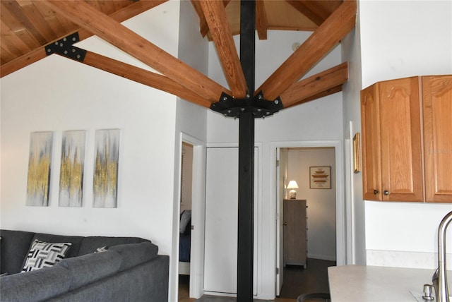 living room featuring high vaulted ceiling and beamed ceiling