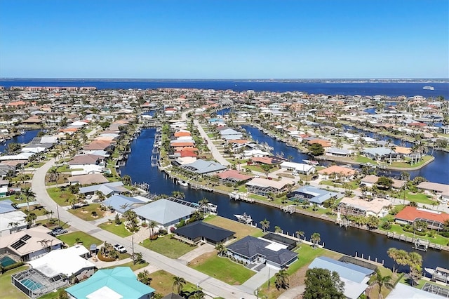 drone / aerial view featuring a water view and a residential view