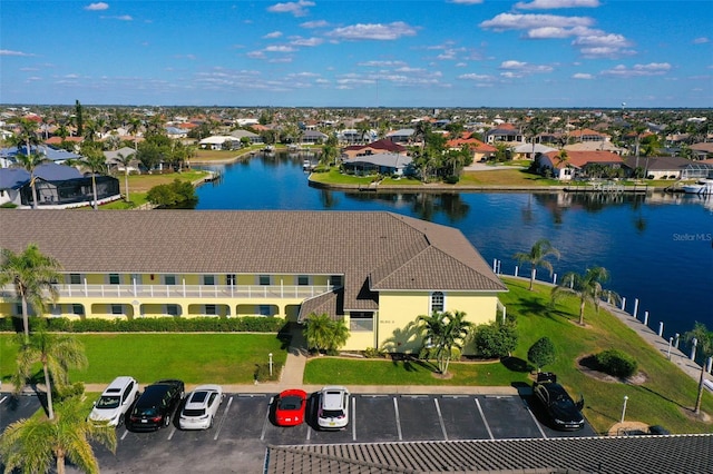 drone / aerial view featuring a water view and a residential view