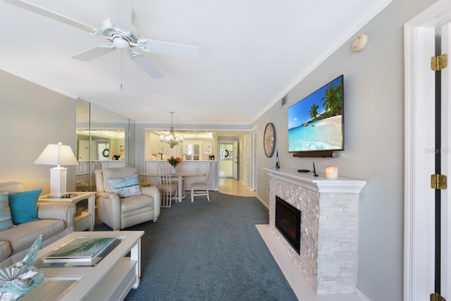 living area featuring ceiling fan, ornamental molding, dark carpet, and a fireplace with flush hearth