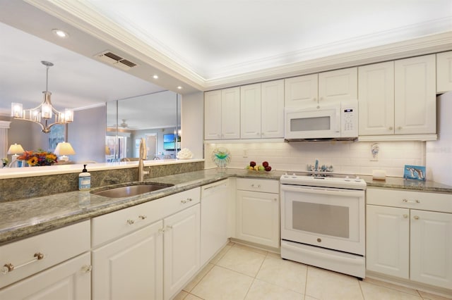 kitchen featuring white appliances, a sink, visible vents, white cabinets, and dark stone counters