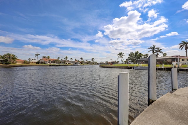 view of dock with a water view and a residential view