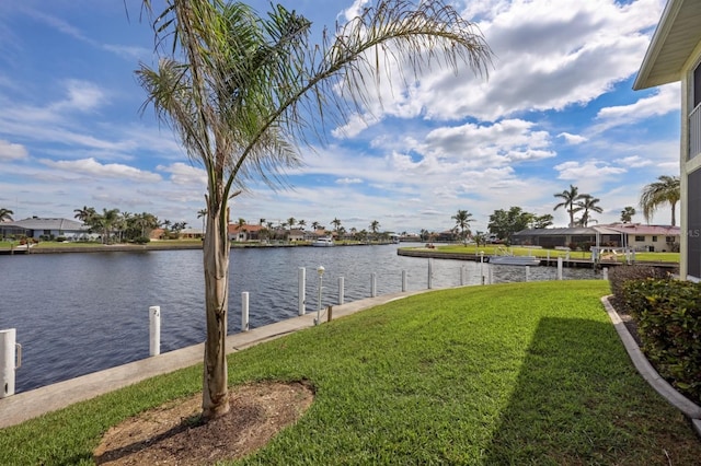 view of yard featuring a dock and a water view